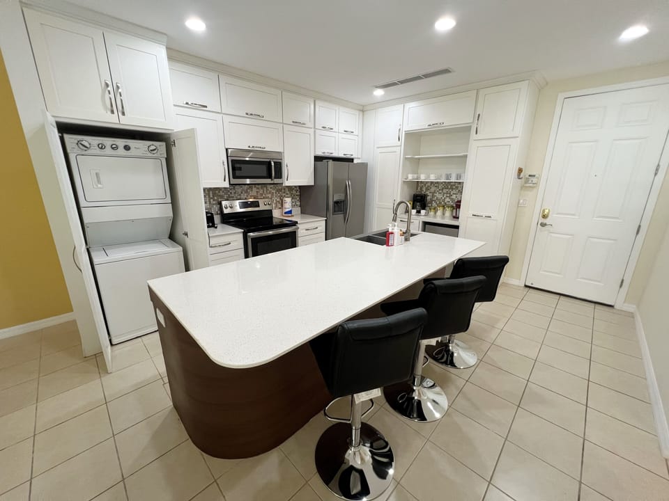 The condo has an updated kitchen featuring stainless steel appliances, in-suite laundry and breakfast bar seating.