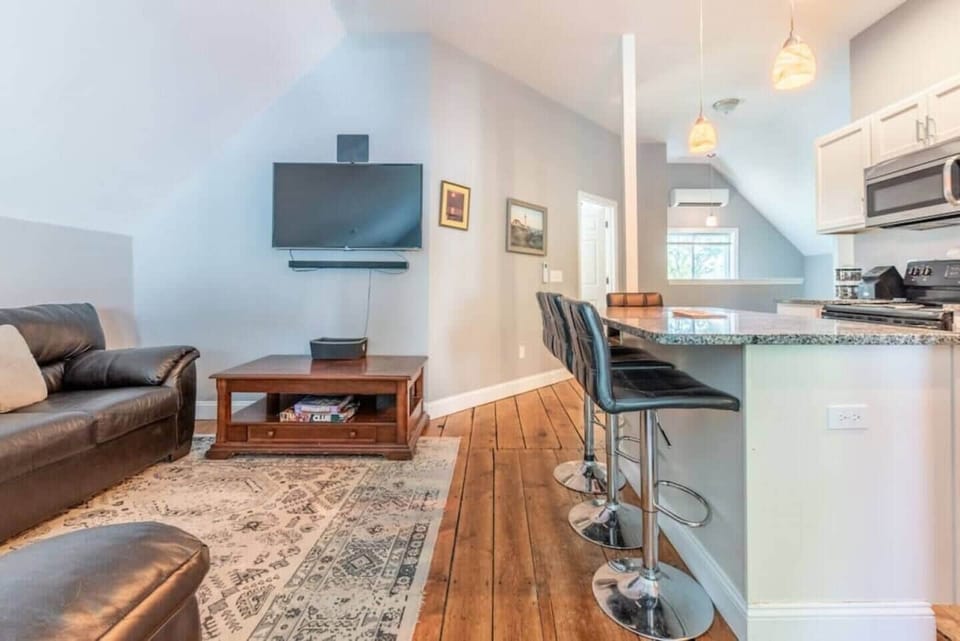 Open concept from kitchen to living room and smart tv.