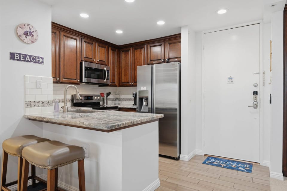 Two additional seats at the kitchen counter offer extra dining space or a spot for casual bites