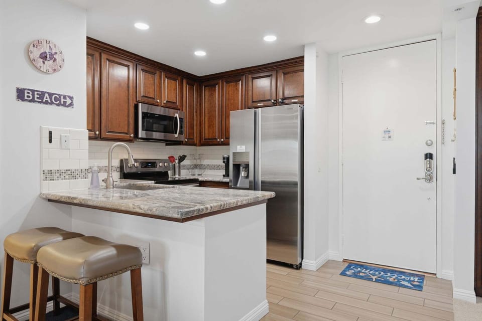 Two additional seats at the kitchen counter offer extra dining space or a spot for casual bites