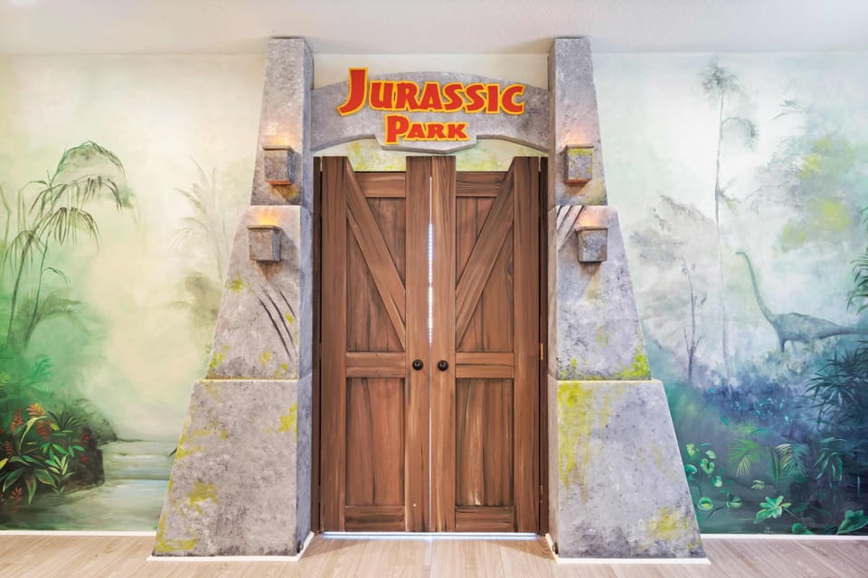 - Jurassic Park themed game room entrance with immersive décor  
- Custom murals and creative design bring adventure to life  
- Orlando family vacation rental with themed entertainment