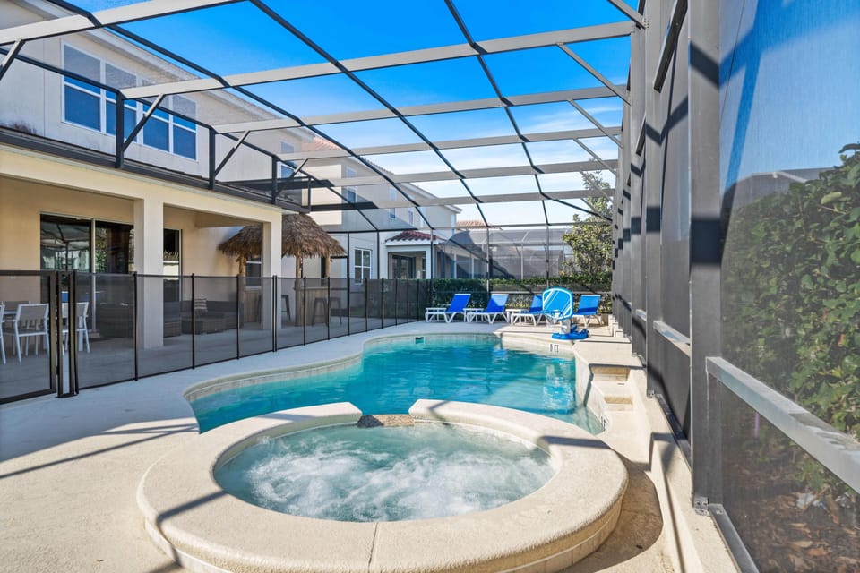 - Screened private pool with relaxing spa and lounge chairs  
- Spacious patio seating perfect for sun and shade enjoyment  
- Orlando vacation rental with private pool near theme parks