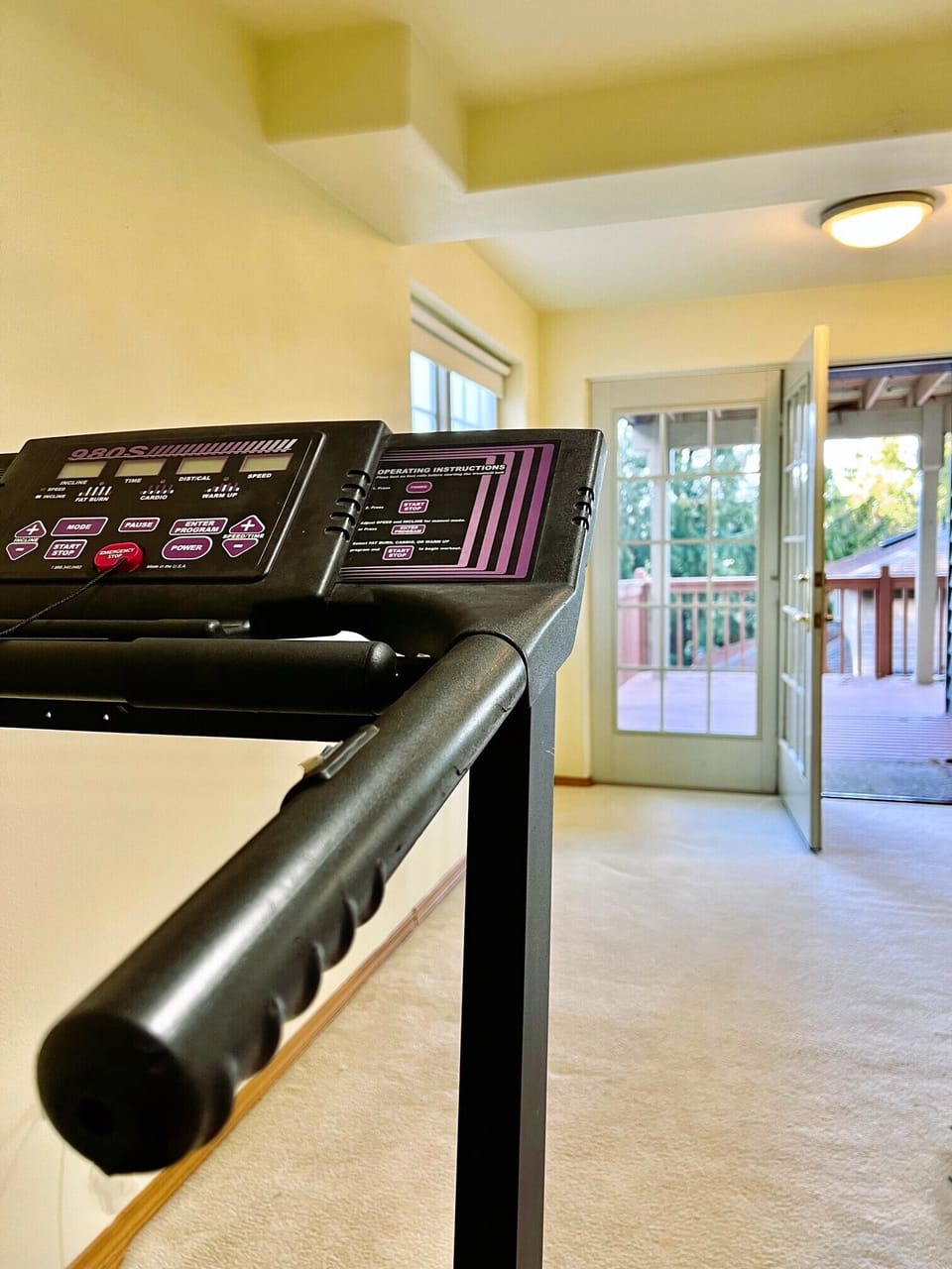Fitness equipment overlooking outside patio. 