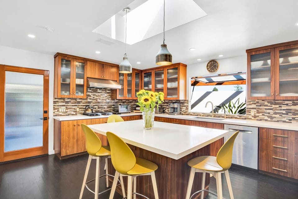 Kitchen island with high chairs to match as the centerpiece.