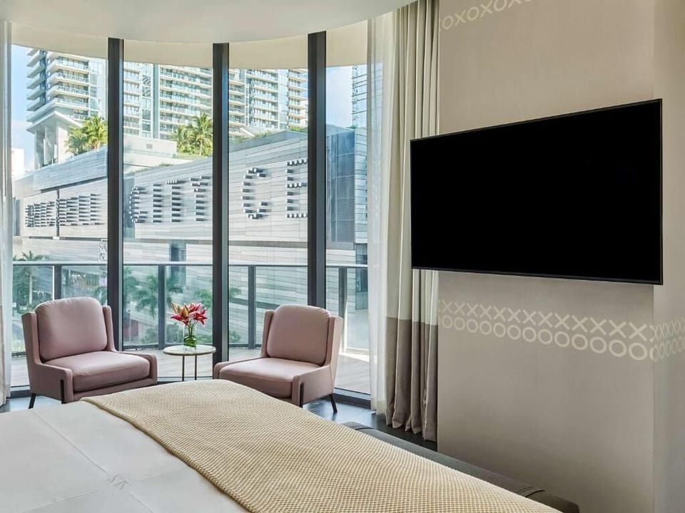 Relax in bed with big-screen entertainment and soft lounge chairs.