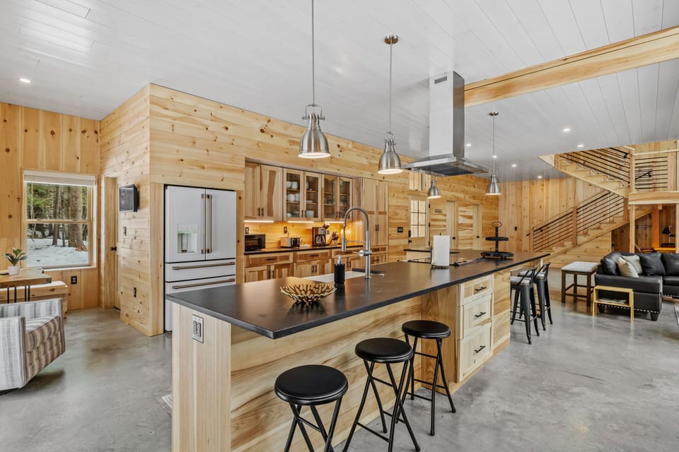The kitchen is open to the living and dining space and features a breakfast nook.