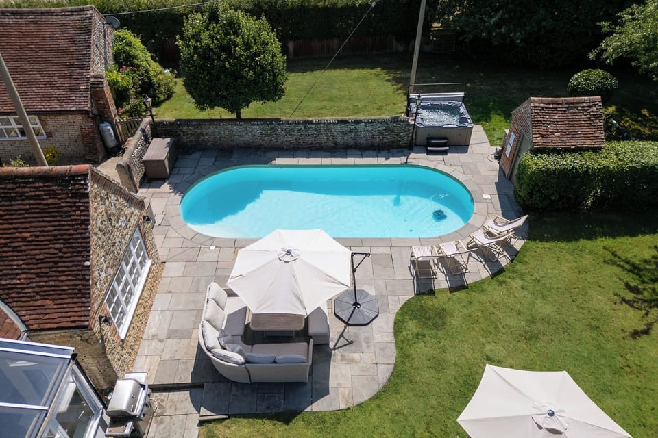 Outdoor area with heated pool, hot tub and seating area
