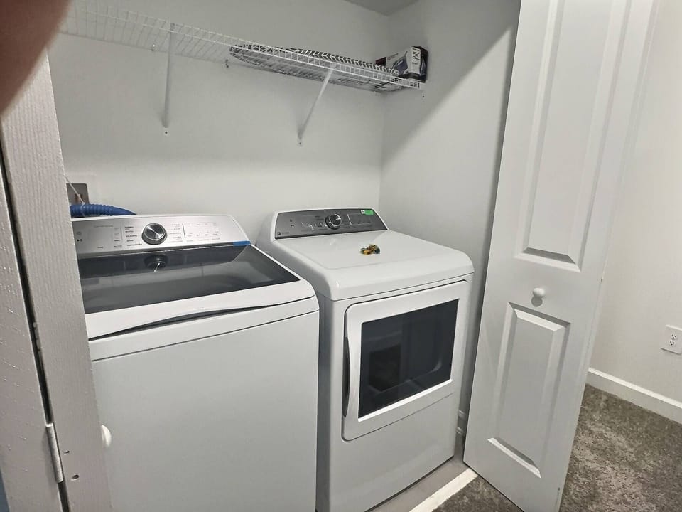 Enjoy the convenience of an in-unit laundry area featuring sleek, modern appliances. The clean lines and bright lighting create a functional space that ensures your stay remains hassle-free and comfortable.