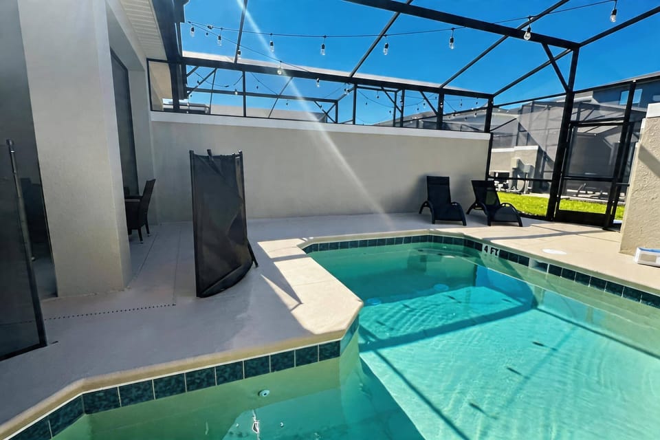 Step outside to your private oasis, where a shimmering pool invites you to unwind under the sun. With sleek, modern fencing and cozy lounge chairs, this outdoor space is perfect for leisurely afternoons and starry evenings.