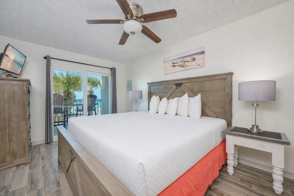 King bed in the master suite invites you to rest deeply while hearing gentle waves beyond the balcony door