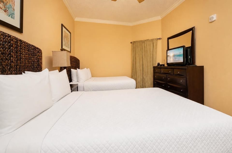 Relax in the inviting guest bedroom, enjoying movies on the TV or cozy moments on two queen beds with soft linens