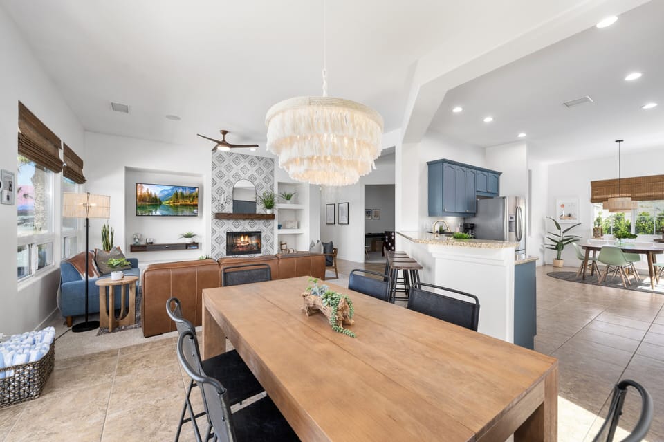 Handmade boho chandelier hangs above the dining table with seating for six. 