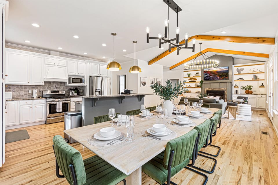 The dining table seats 10 and sits between the kitchen and living room in the open floor plan. Set the table, plate up dinner, and everyone's together.