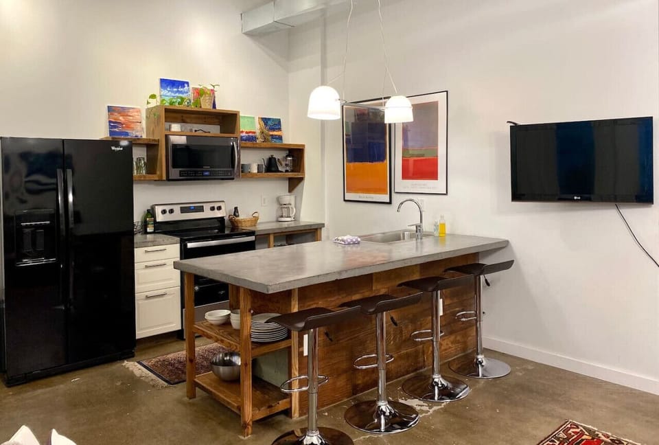 Concrete countertops, wood from island reused from the building, local art