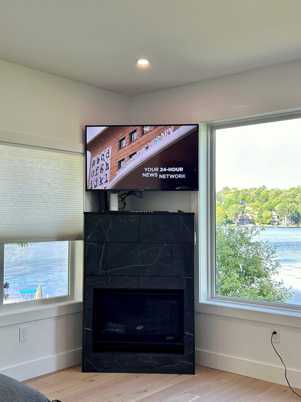 HDTV over a marble fireplace.