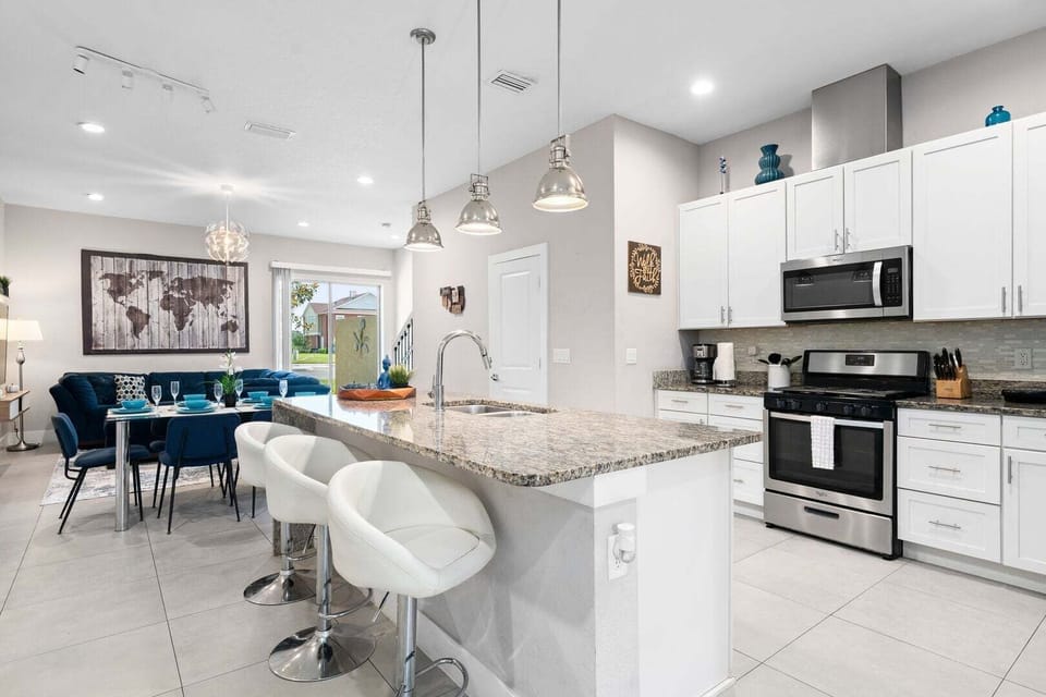 Cook with ease in a kitchen featuring stainless steel appliances and all essentials.