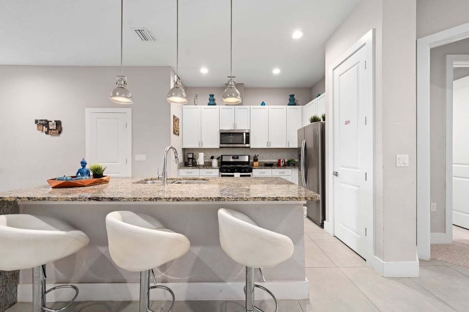 Fully equipped kitchen with modern stainless steel appliances.