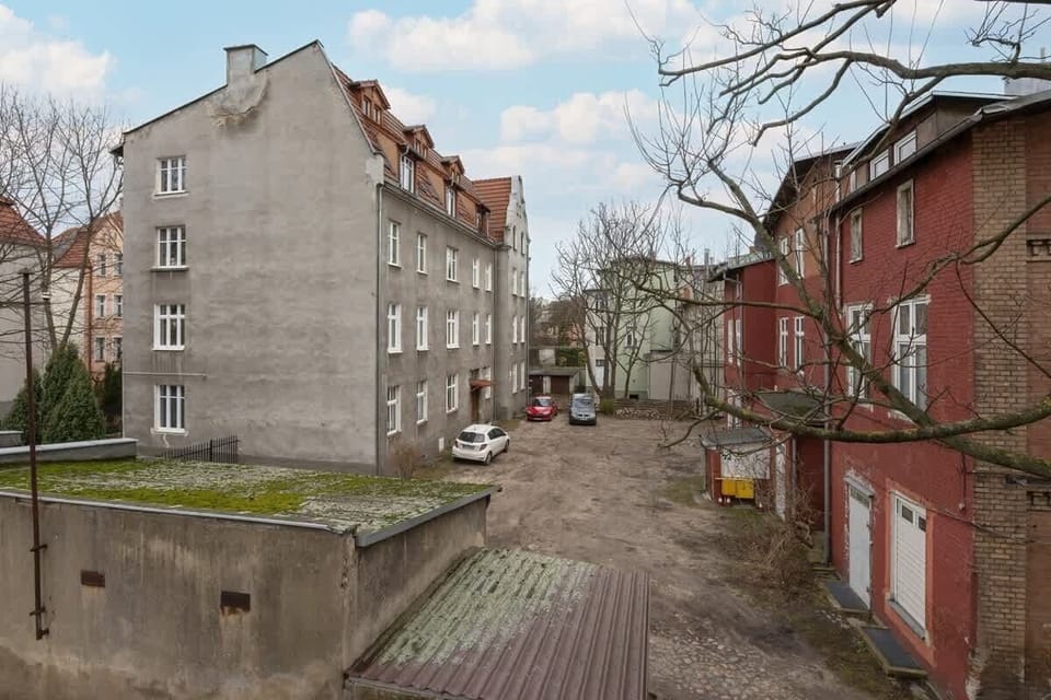 A quiet residential alley with a blend of old and new architecture, highlighting the neighborhood's character and history.








