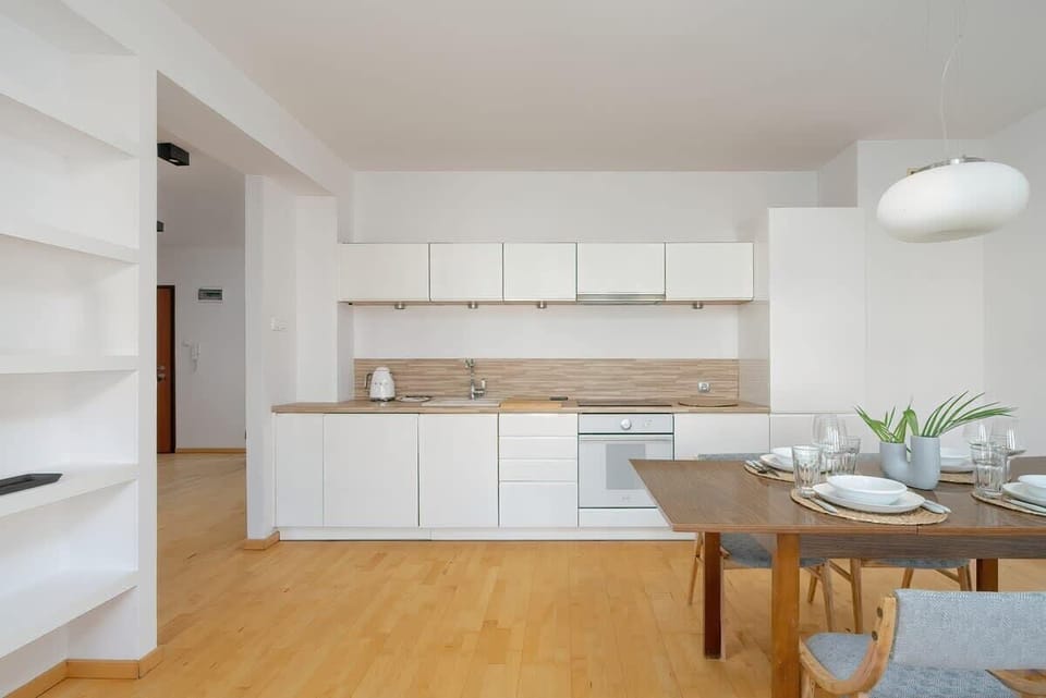 A different angle of the kitchen, displaying the spacious cabinetry, a well-organized workspace, and sleek appliances.

