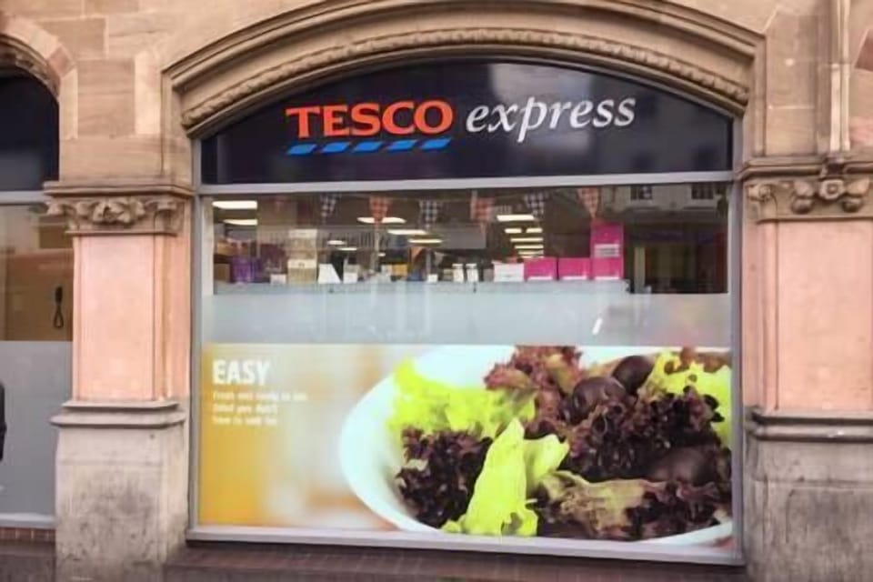 Tesco Supermarket, 2 doors away - about 10 metres.