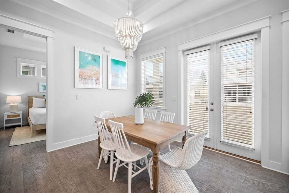 Large windows bring in sunshine, making meals even more enjoyable in this spacious dining room.