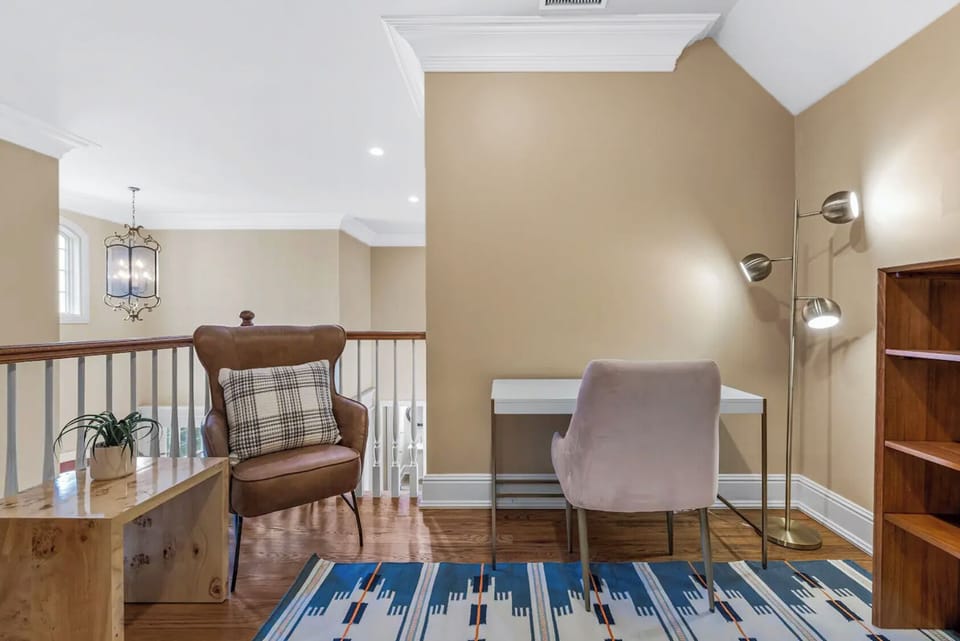 Upper-level workspace with two stylish chairs.