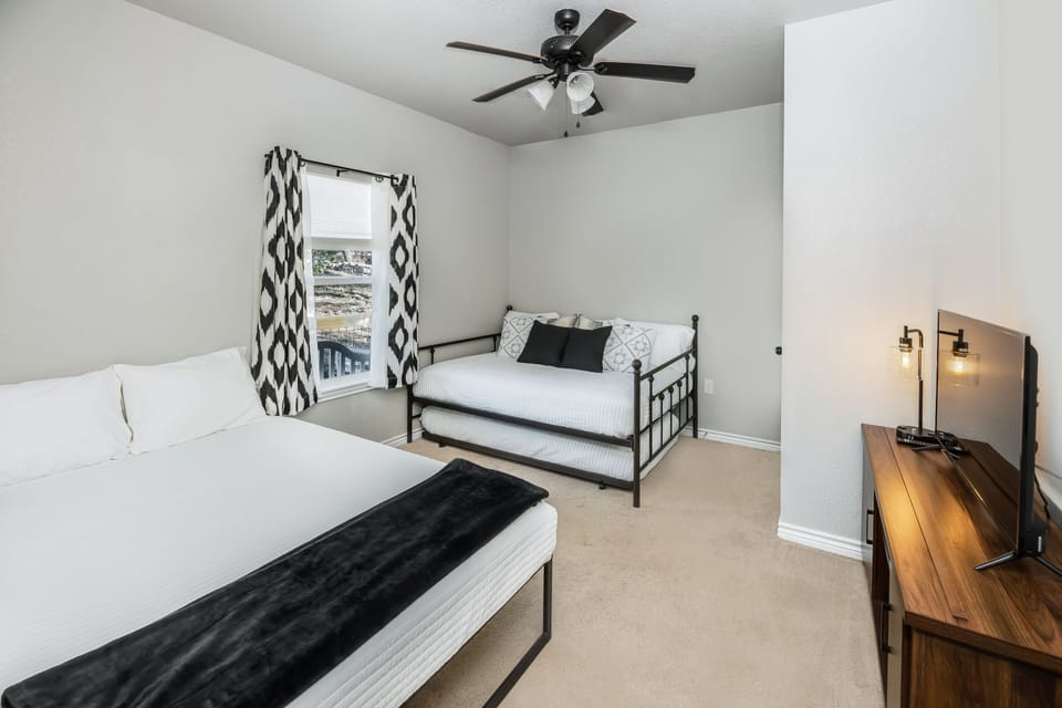 The third bedroom has a queen bed, full bed, and a trundle twin bed underneath. 