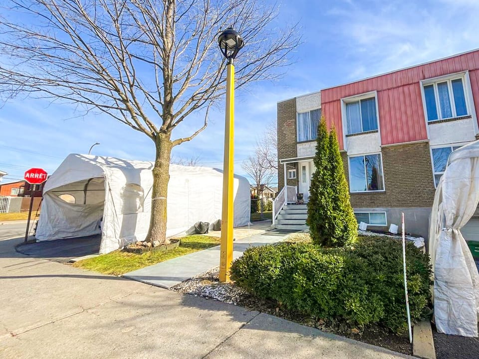 Facade of the house with two parking spot on the left