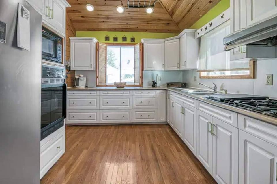 Full size kitchen with gas burners and wall ovens. 