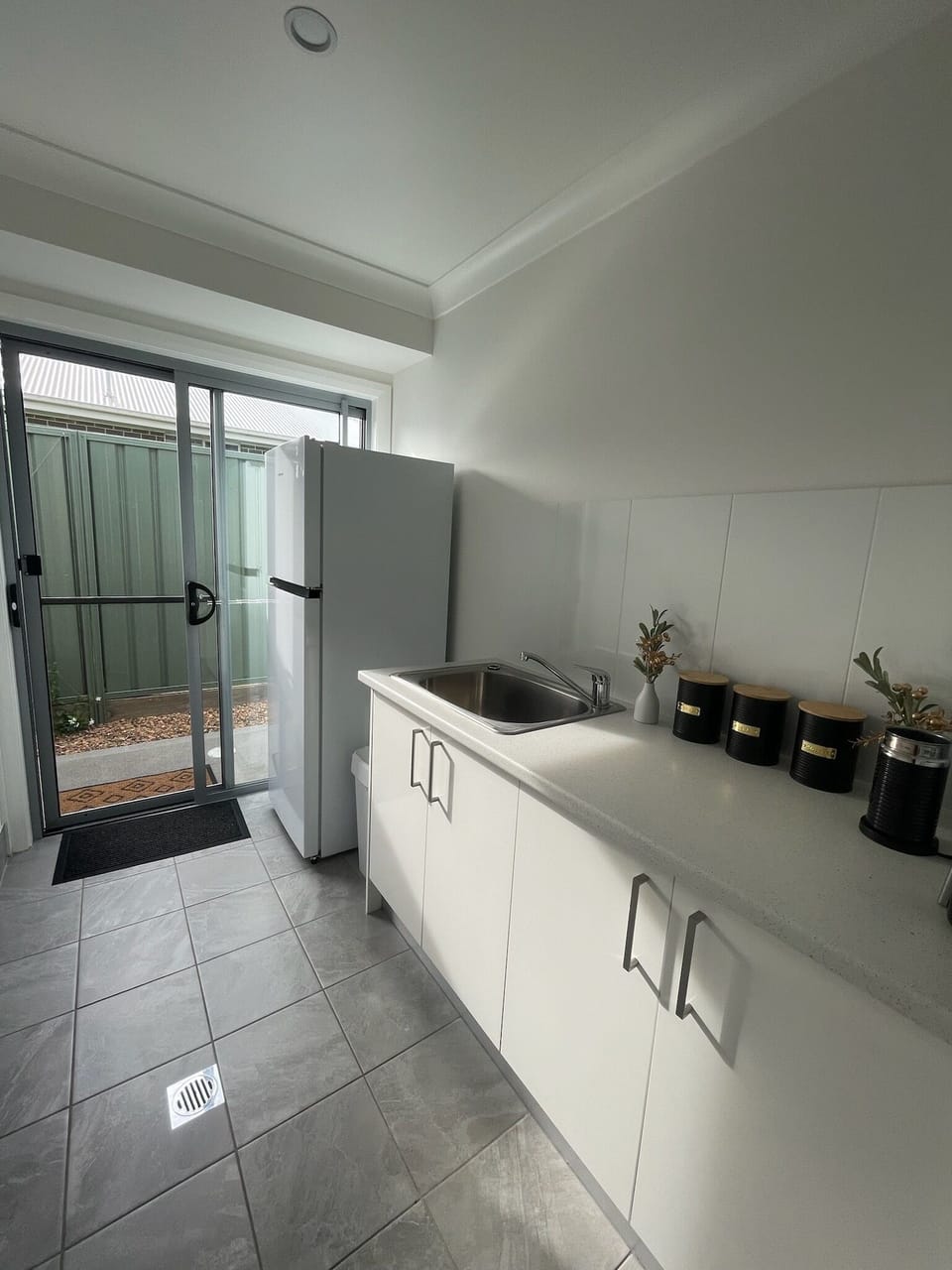 kitchenette with full size fridge and essential appliances.  