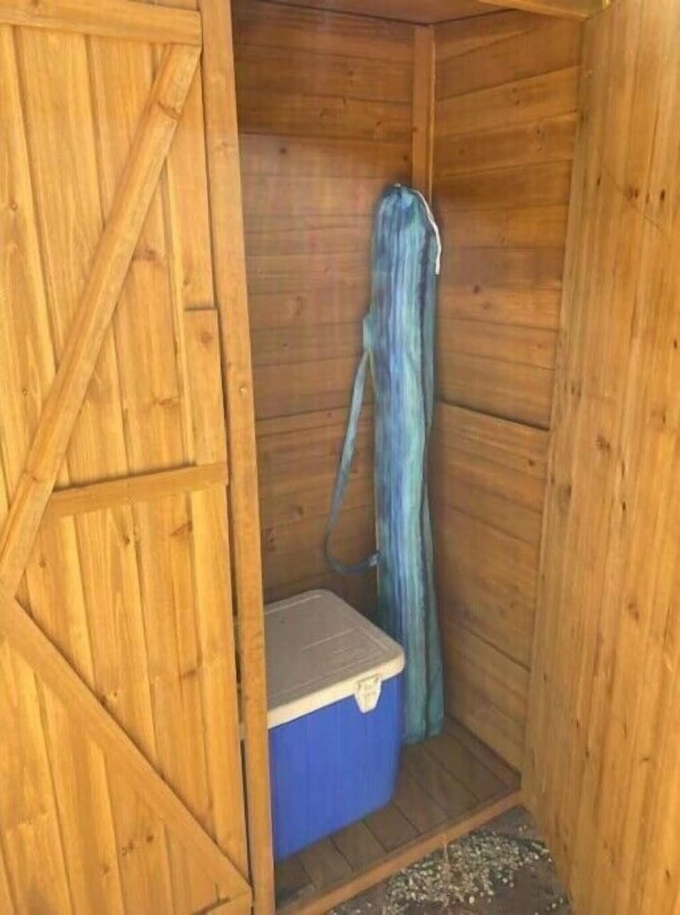 Beach supplies and cooler.  Beach towels are stored in the closet inside.
