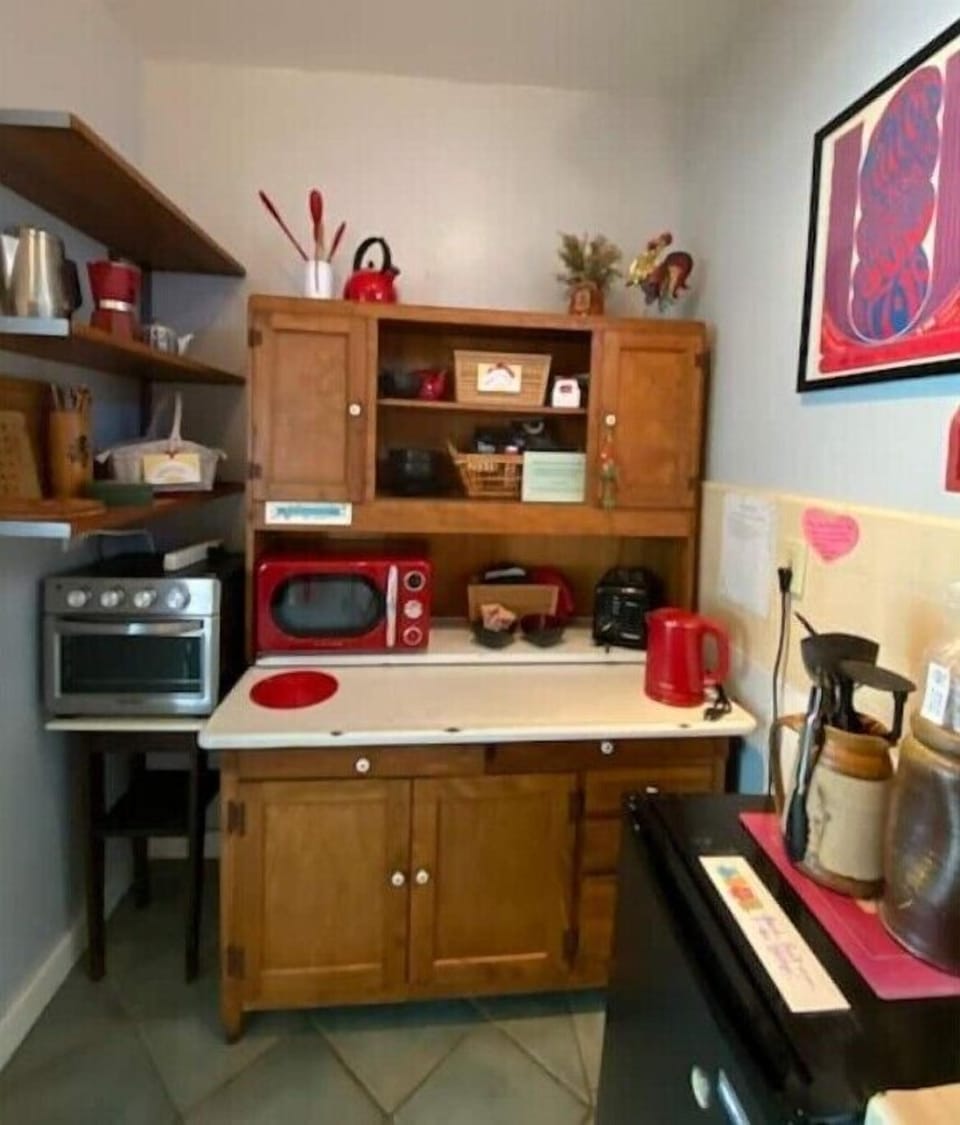 Kitchen with Hoosier cabinet for staples, pots and pans, coffee and tea supplies