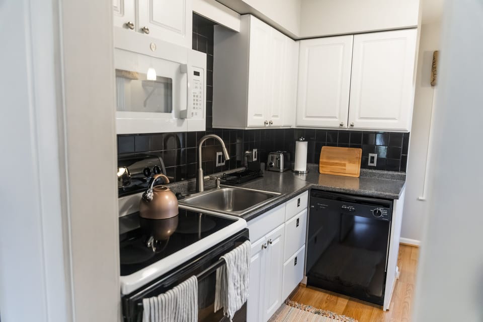 Kitchen supplied with pots & pans, cooking utensils, plates, cups, spices, etc.