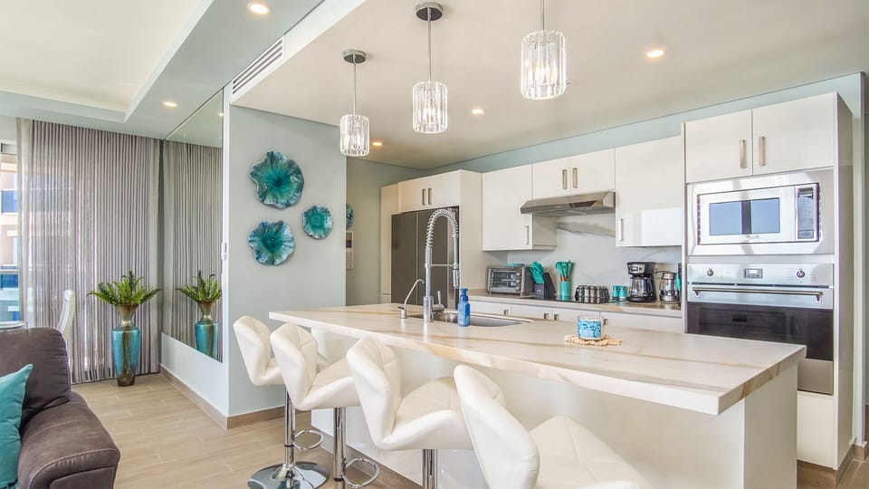 Large open  ended island with leather stools.