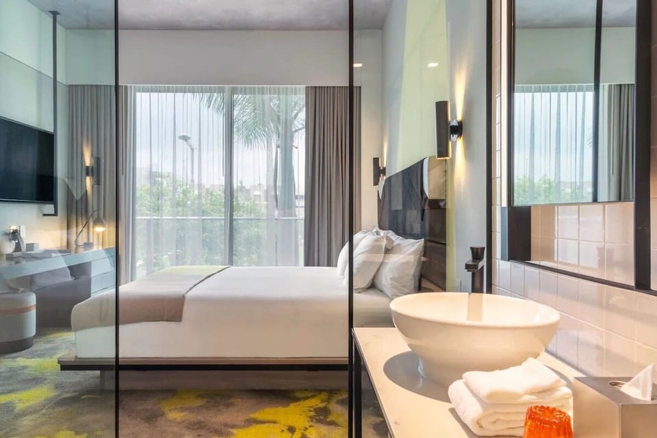 Indulge in boutique-hotel style with glass-partitioned vanity views.