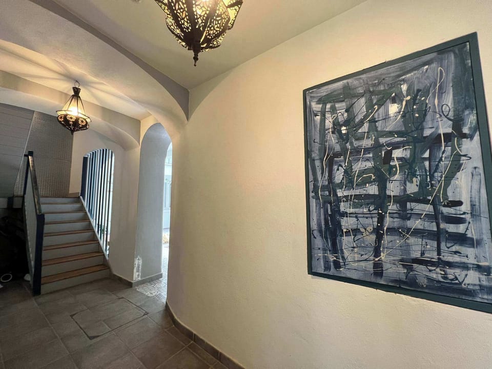 Hallway and stairwell leading to apartment