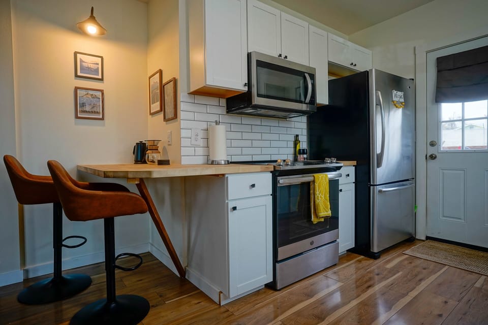 one of two dining areas, microwave, stove, oven, refrigerator, freezer