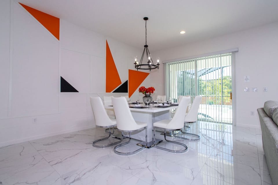 The living room, dining area, and kitchen seamlessly blend into one cohesive space.