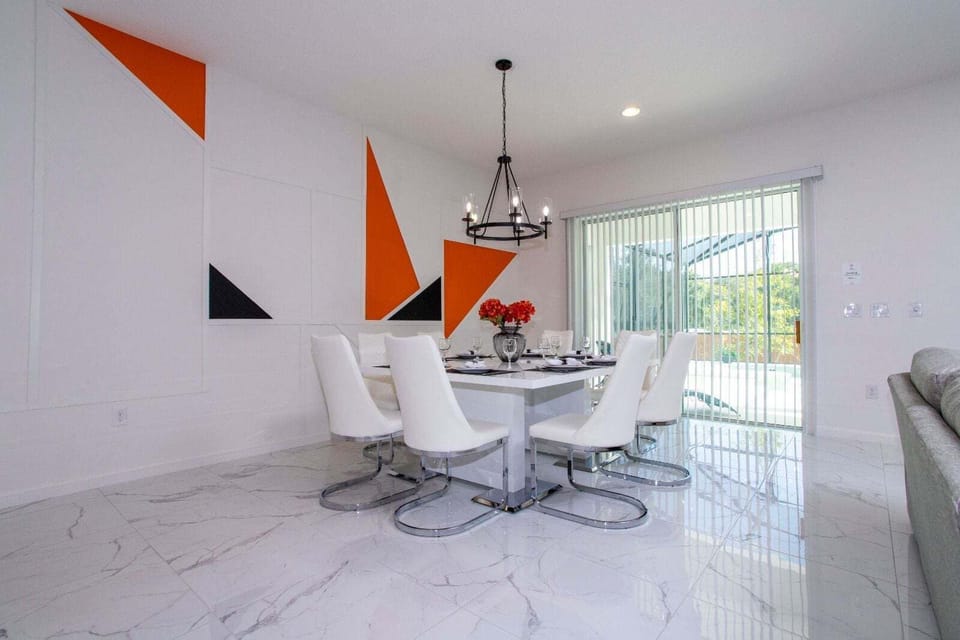 The living room, dining area, and kitchen seamlessly blend into one cohesive space.