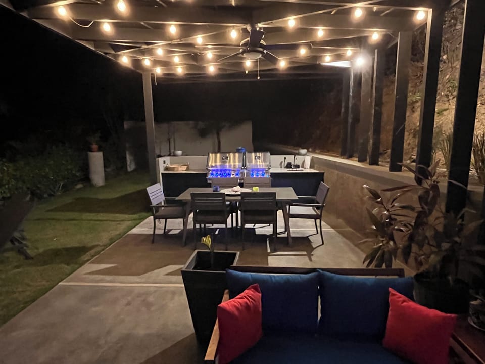 Covered patio with large multifunction grill and plenty of space for everyone!