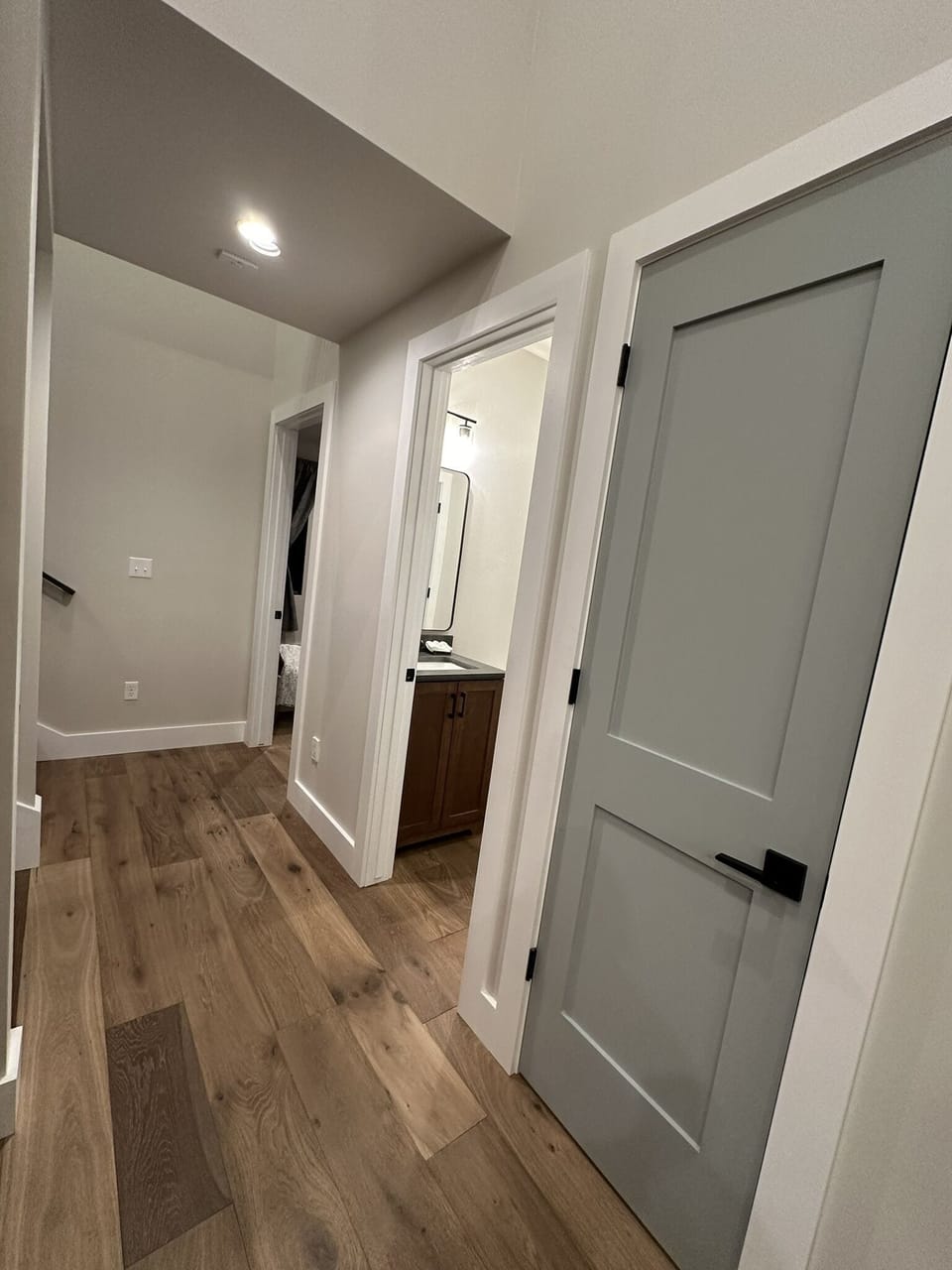 Hall from kitchen to master suite, half bath on the right