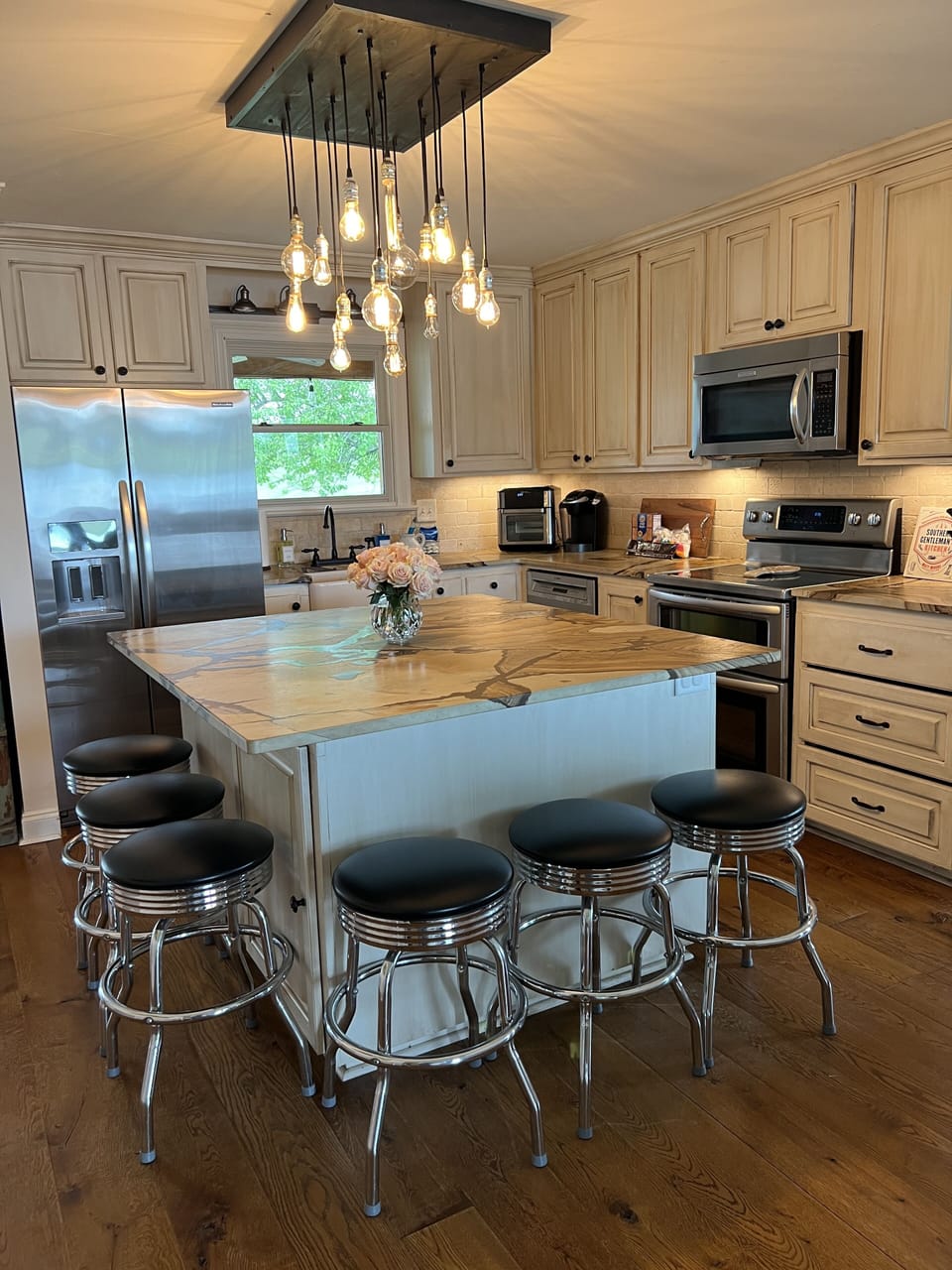Fully equipped kitchen with quartzite leather countertops and barstool seating.
