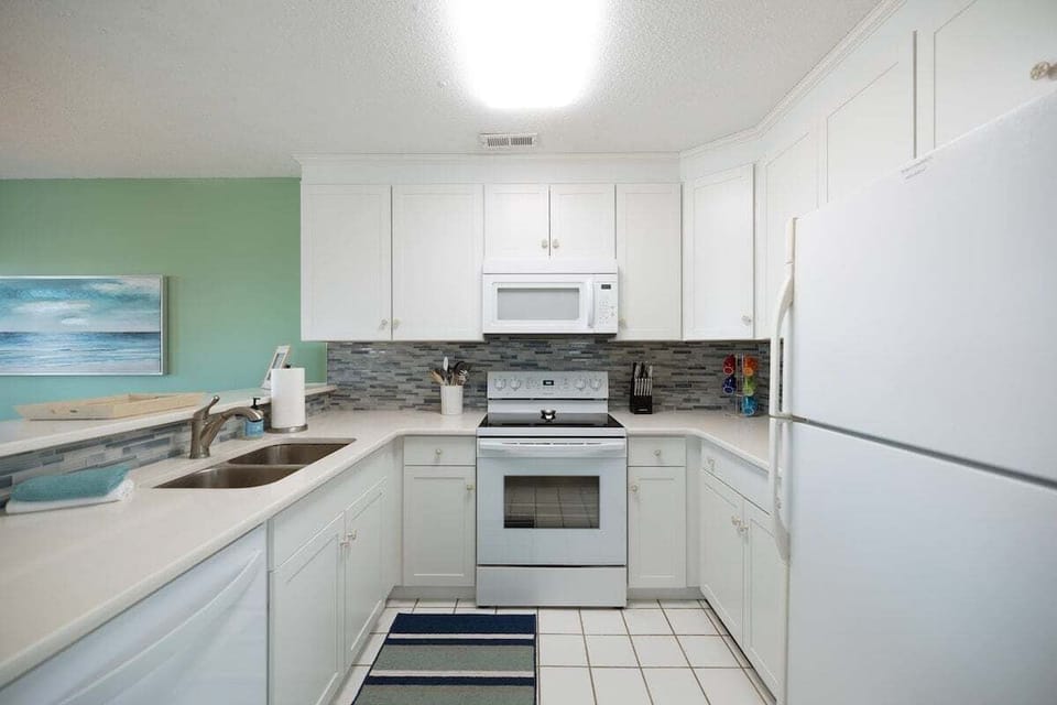 Newly renovated kitchen featuring Quartz countertops, modern appliances, and everything needed for cooking, entertaining, and hosting family meals.