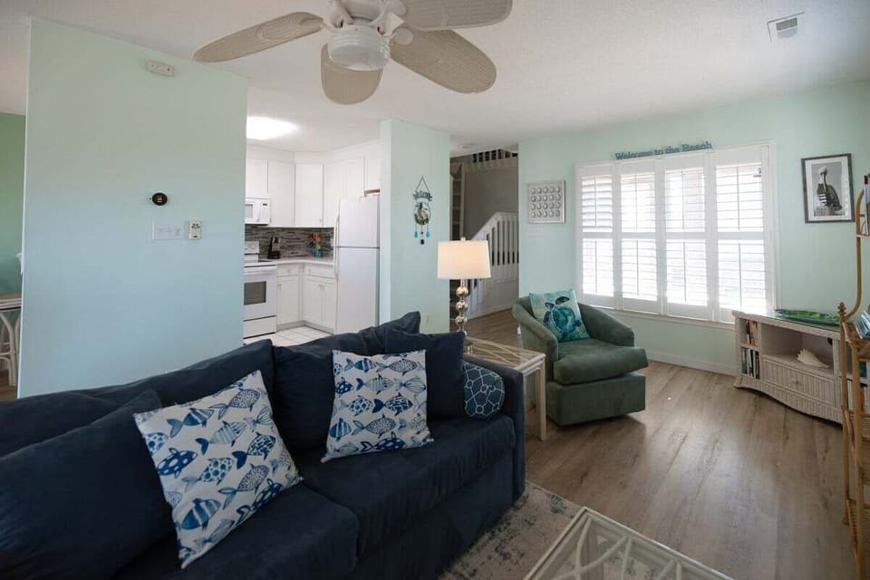 Cozy living room equipped with a 65-inch Smart TV, electric fireplace, and ample seating