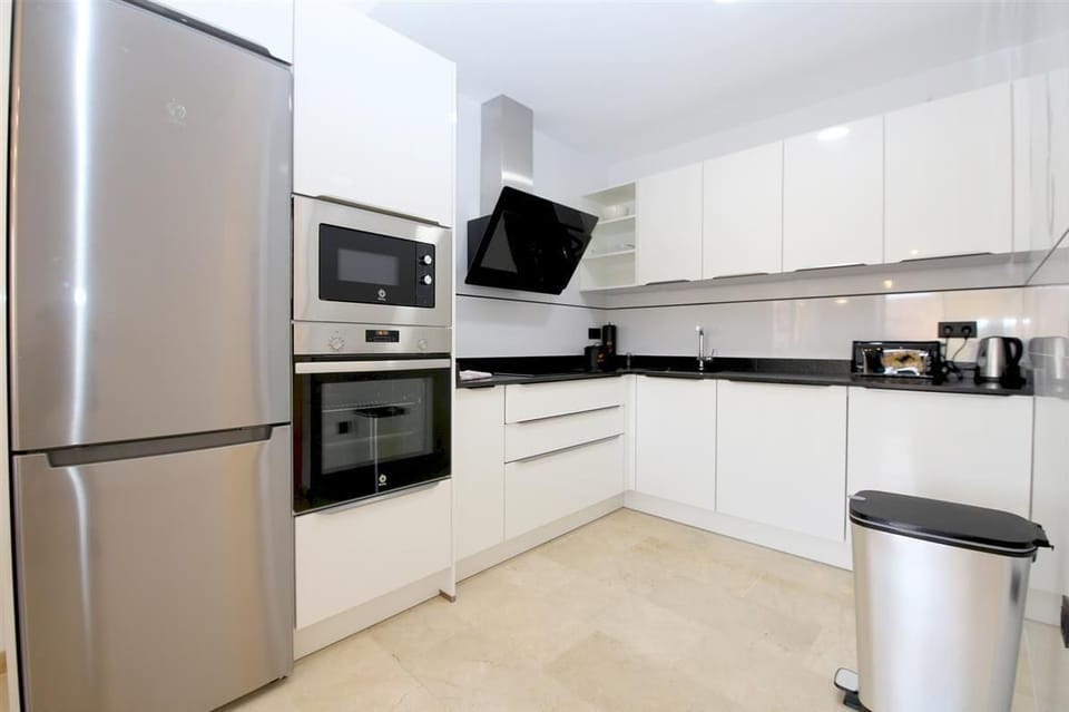 Modern open kitchen is fully equipped with all the appliances