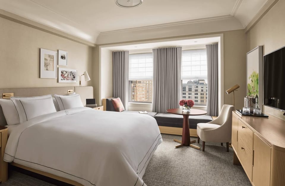 Unwind in crisp linens with sweeping city views beyond.