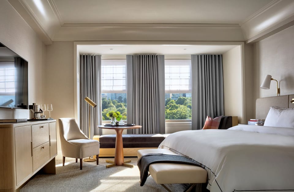 Sip morning coffee by sunlit windows overlooking lush parkland.