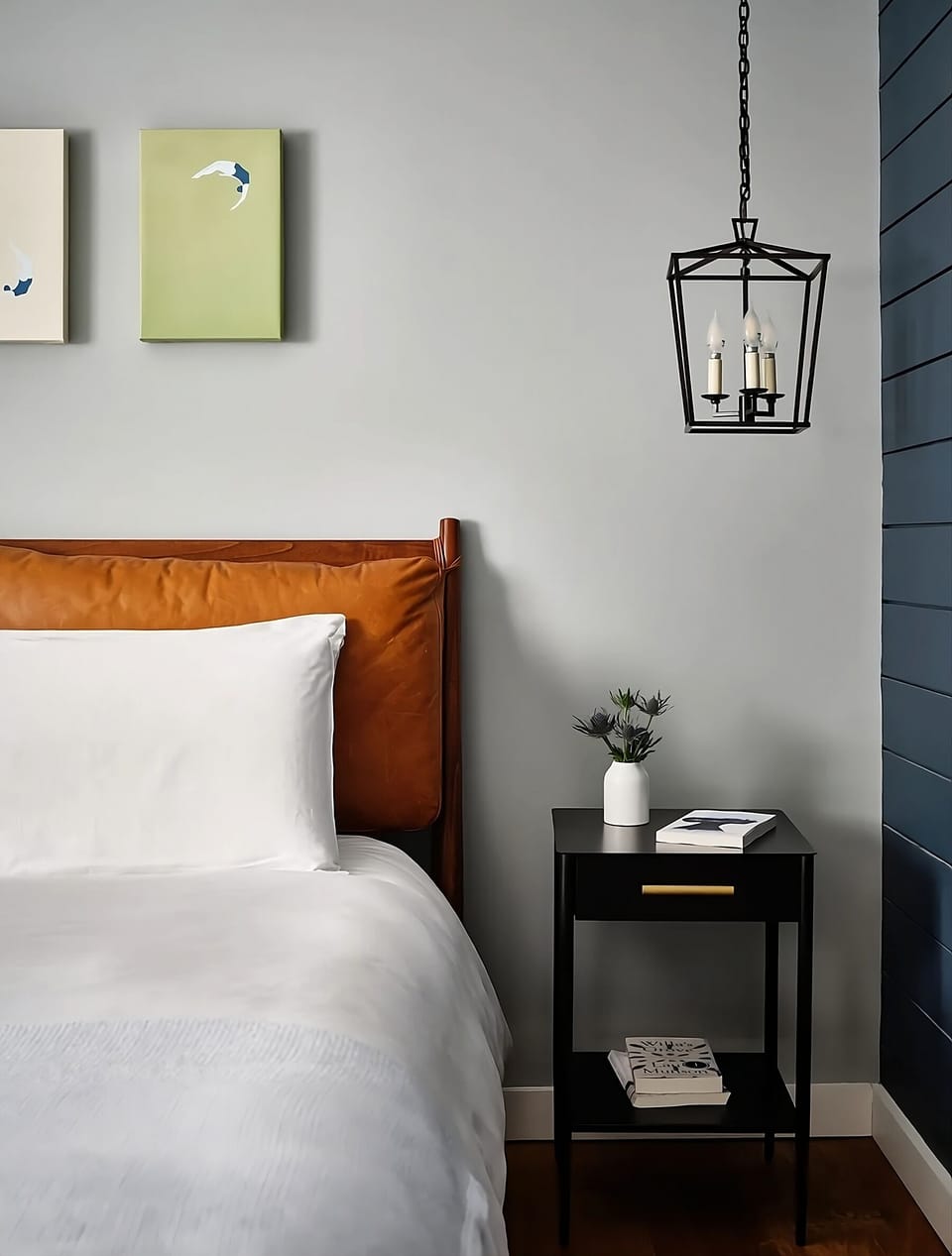 Drift off beside warm lighting and thoughtful bedside touches.