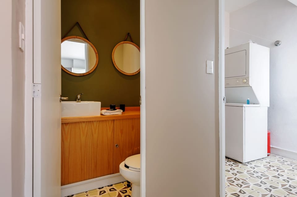 Stylish bathroom with round mirror.