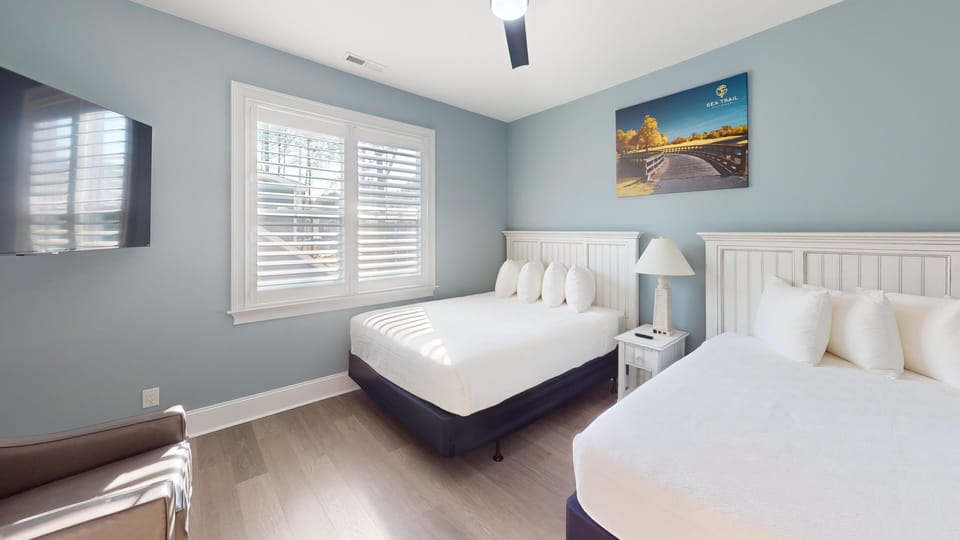 Second guest bedroom with contemporary décor and comfortable sleeping arrangements.